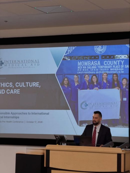 IMA Founder and Managing Director at a podium in front of the Ethics, Culture, and Care slide in TLC 1010